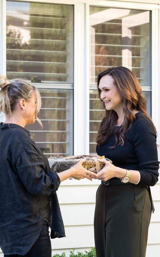Cass handing a settlement gift to a client